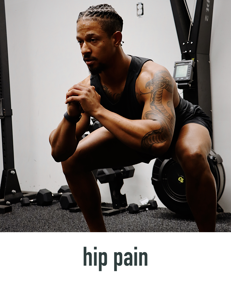 Man with tattoos on his arms and legs in a gym setting, with 'hip pain' text at the bottom.